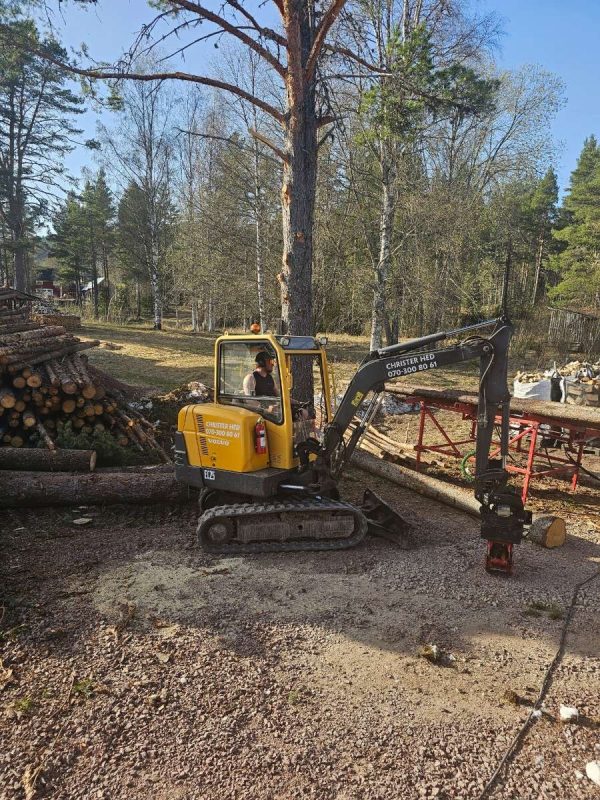 Lastning av ved på vedbordet med grävaren